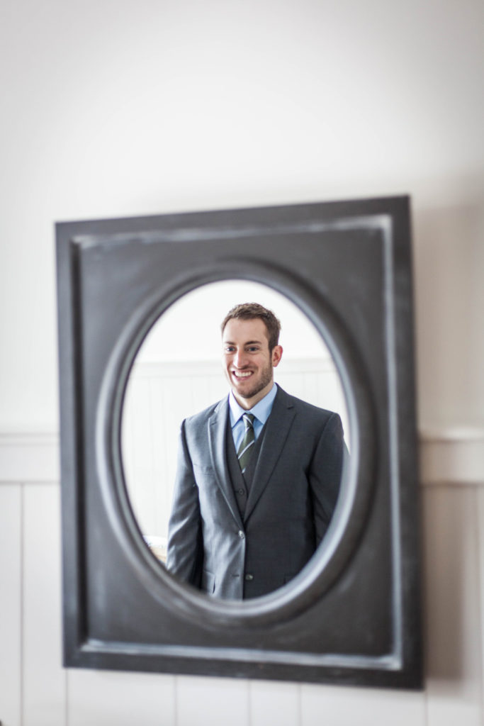 elope to ireland ballycarbery castle groom looking in the mirror