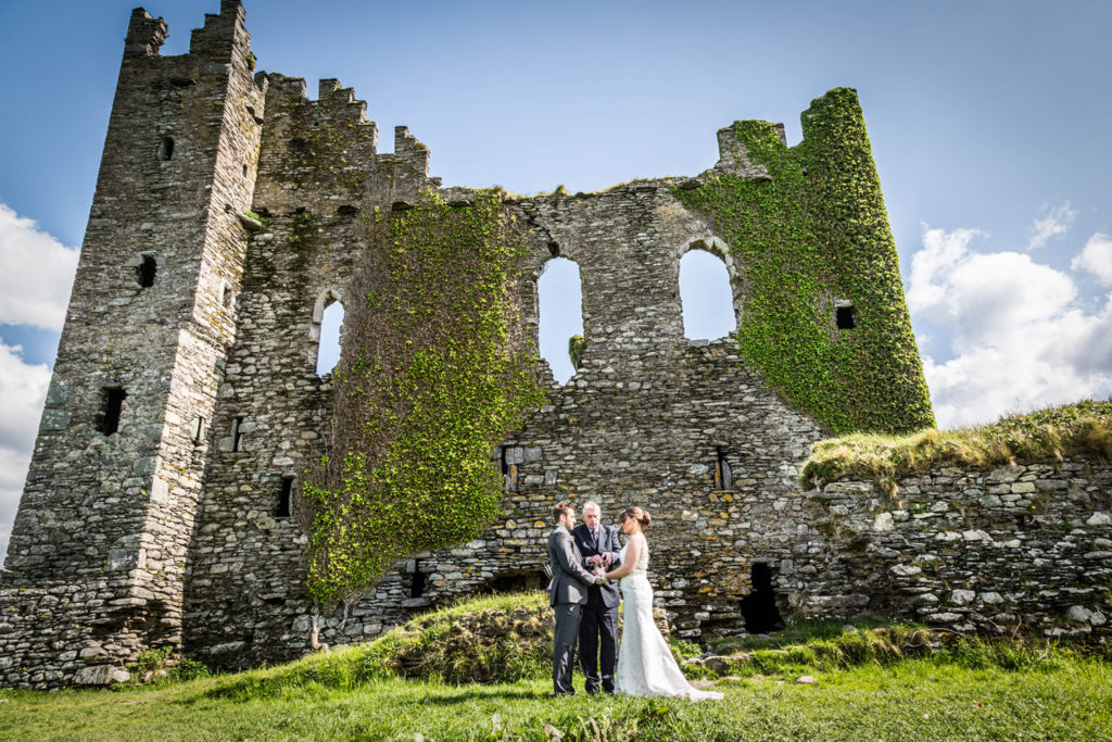 ceremony in front of Ballycarbery castle elope to ireland