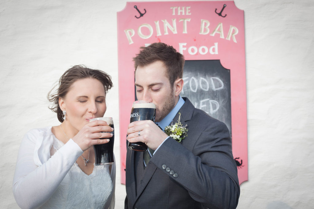 elope to ireland couple having a pint in the point bar