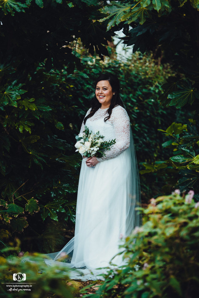 bride with bouquet in the church grounds Traditional Church Ceremony on Valentia Island