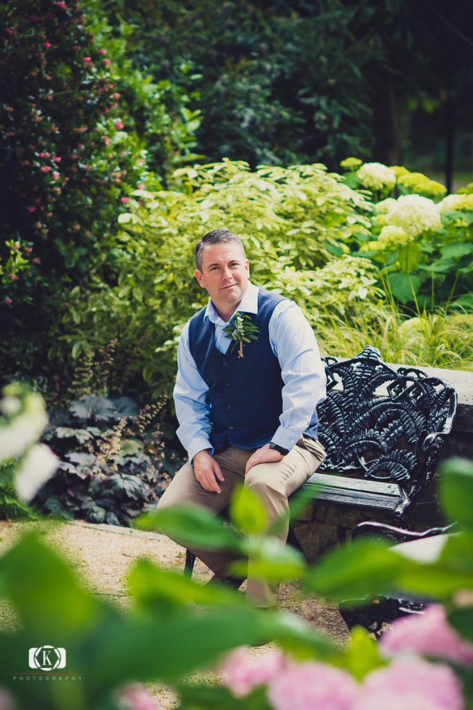 Elope to Ireland elopement in dublin ireland on a cliff groom siting on a bench before the ceremony