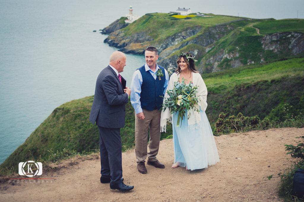 Elope to Ireland elopement in dublin on Howth lighthouse walk cliff groom start of the ceremony with spiritual ceremonies