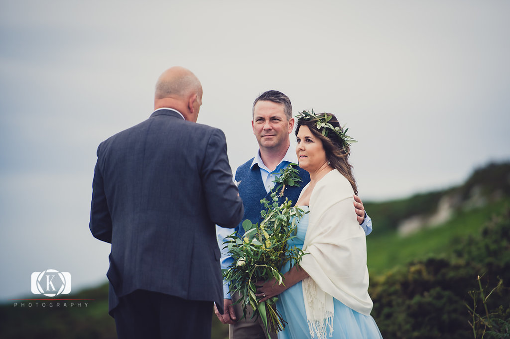 Elope to Ireland in dublin on a cliff at the Howth lighthouse walk bride and groom ceremony with spiritual ceremonies