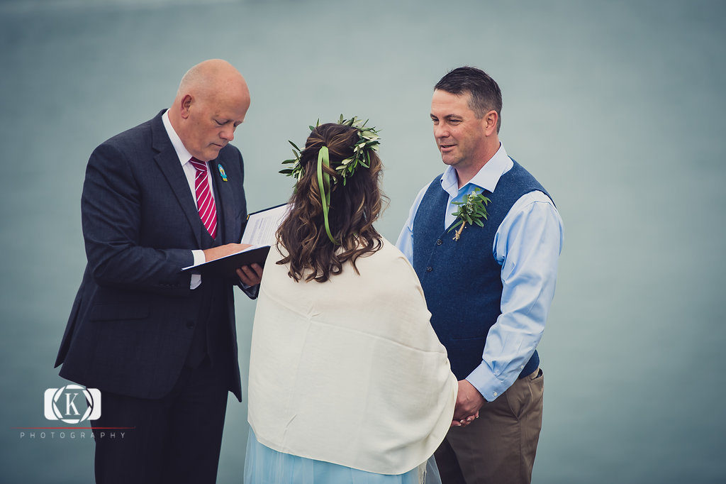 Elope to Ireland in dublin on a cliff at the Howth lighthouse walk bride and groom ceremony