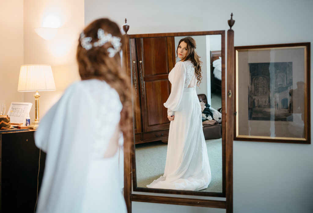 brdie looking in at the mirror before her An Elegant Spring Elopement in West Cork at Bantry House 