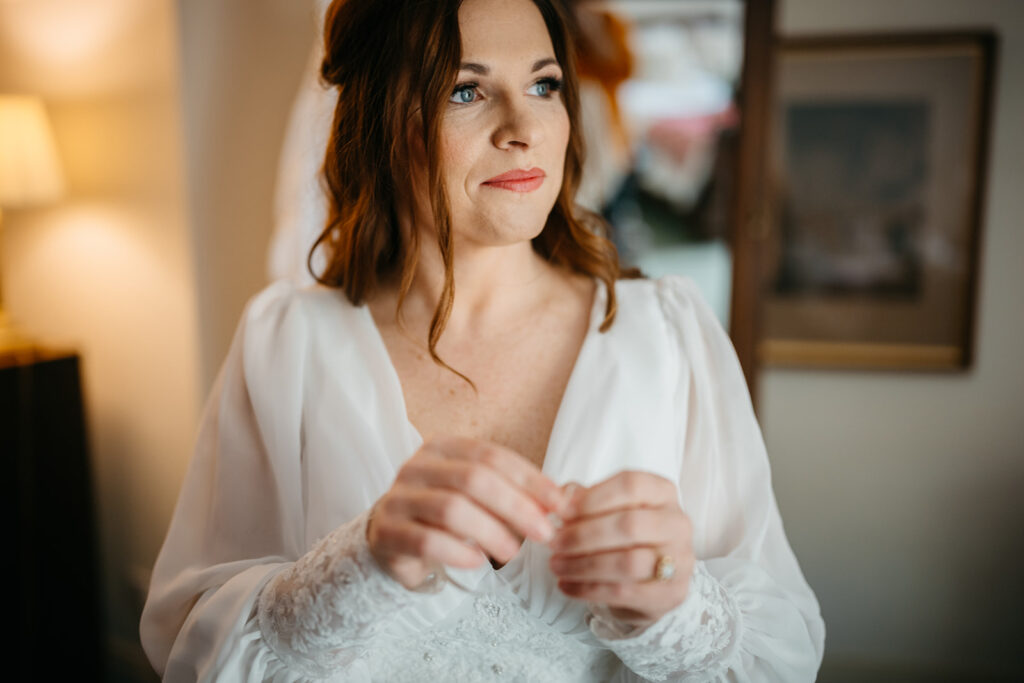 the bride looks ponderously into the distance before an Elegant Spring Elopement in West Cork at Bantry House 