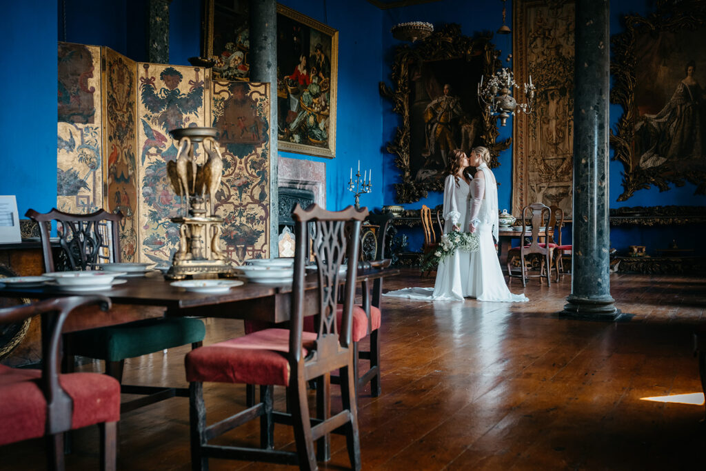 beautiful west Cork wedding ceremony at Bantry House brides standing close to gether in an elegant room why people decide to elope to ireland 
