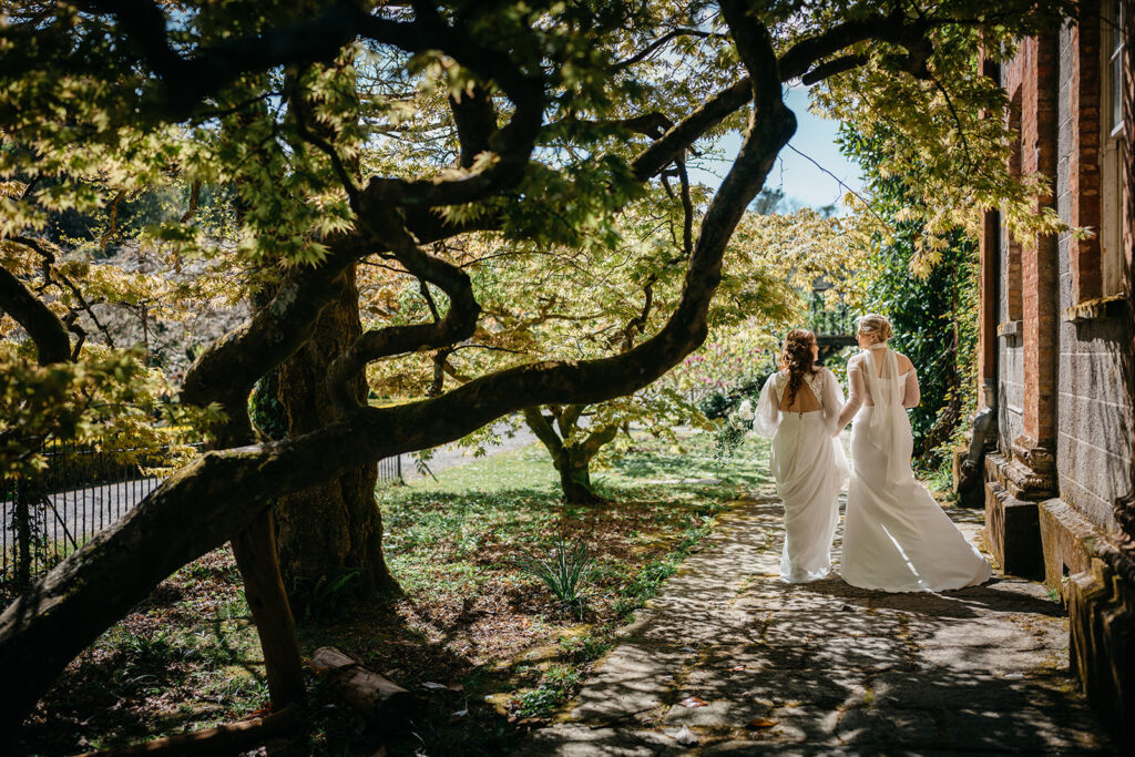 beautiful west Cork wedding ceremony at Bantry House brides sitting close together in bantry house garden.10 years of Marriage Equality in Ireland