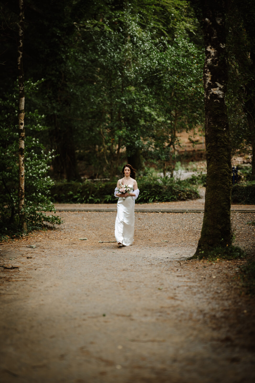 bride walking to the groom for a fist look at the beach 