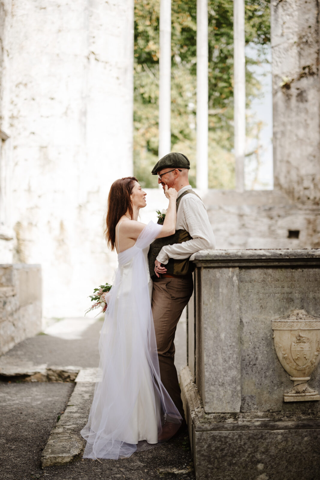 bride and groom embracing at Muckross abbey 